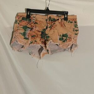 Distressed floral denim shorts